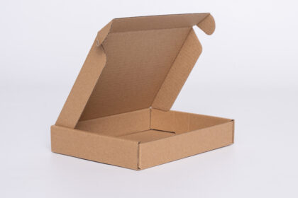 A flat, brown colored, Kraft shipping box, suitable for both storage and mailing needs. The box is made of durable Kraft material and can be easily assembled when ready for use. The brown color and plain design allows it to blend in seamlessly with any environment, making it perfect for both personal and professional use. The size of the box can vary, depending on the contents that need to be stored or shipped, making it a versatile option for all your storage and mailing needs.